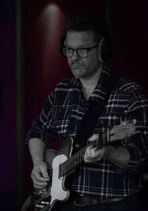 Guitarist Peter Gunnebro records his electric guitar in the studio