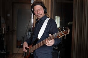 Bass player Thomas Midemyr records his electric bass in the studio