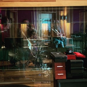 View from recording room through the window toward the control room